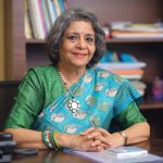 Woman in traditional attire at desk.